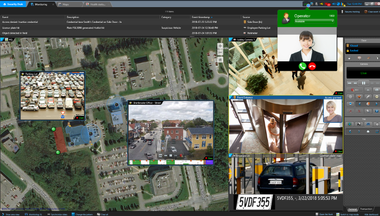 A security operator monitors live camera feeds and map-based video analytics for multiple facility locations, managing access points, visitor calls, and vehicle entry from a unified security dashboard.